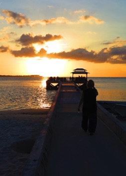Leslie walks to pier end bar
